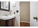 Cozy half-bathroom features a lovely decorative mirror, a dark wooden cabinet, and neutral paint at 5086 N Woodbridge Trl, Stone Mountain, GA 30088