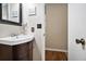 Powder room with modern vanity, decorative mirror, and fixtures at 5086 N Woodbridge Trl, Stone Mountain, GA 30088