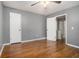 This cozy bedroom has hardwood floors, a ceiling fan, and two separate closets for convenient storage at 5086 N Woodbridge Trl, Stone Mountain, GA 30088