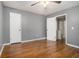 Neutral bedroom featuring hardwood floors, ceiling fan, and two closets at 5086 N Woodbridge Trl, Stone Mountain, GA 30088