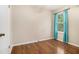 Bedroom featuring hardwood floors, window with blinds, and neutral walls at 5086 N Woodbridge Trl, Stone Mountain, GA 30088