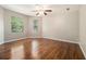 Spacious bedroom with hardwood floors and natural light from multiple windows at 5086 N Woodbridge Trl, Stone Mountain, GA 30088