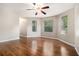 Bright, open bedroom featuring hardwood floors and three large windows at 5086 N Woodbridge Trl, Stone Mountain, GA 30088