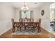Elegant dining room featuring a chandelier, wainscoting, and a large table at 5086 N Woodbridge Trl, Stone Mountain, GA 30088