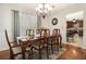 Formal dining room features hardwood floors, chandelier, and access to the kitchen at 5086 N Woodbridge Trl, Stone Mountain, GA 30088