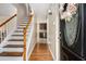 Inviting foyer featuring hardwood floors, a staircase with white rails, and a decorative front door at 5086 N Woodbridge Trl, Stone Mountain, GA 30088