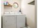 The laundry room includes a standard washer and dryer and a small window for light at 5086 N Woodbridge Trl, Stone Mountain, GA 30088