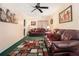 Cozy living room featuring two plush sofas, a colorful rug, and a ceiling fan for added comfort at 5086 N Woodbridge Trl, Stone Mountain, GA 30088