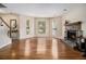 Bright living room with gleaming hardwood floors, bay windows, and a stone fireplace as its focal point at 5086 N Woodbridge Trl, Stone Mountain, GA 30088