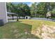 Expansive backyard with a white fence, shed, and covered patio at 1644 Royal Ives Dr, Lawrenceville, GA 30045