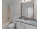 Bathroom with shower/tub combination and vanity with granite countertop at 1644 Royal Ives Dr, Lawrenceville, GA 30045