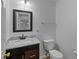 Half bathroom featuring dark brown vanity and marble countertop at 1644 Royal Ives Dr, Lawrenceville, GA 30045