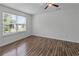 Bright bedroom featuring hard surface floors and a sunlit window at 1644 Royal Ives Dr, Lawrenceville, GA 30045