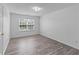 Empty bedroom with a window and wood look flooring at 1644 Royal Ives Dr, Lawrenceville, GA 30045
