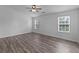 Spacious bedroom features luxury vinyl plank flooring, ceiling fan, and bright natural light at 1644 Royal Ives Dr, Lawrenceville, GA 30045