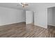 Spacious bedroom with wood-look flooring, ceiling fan, and neutral paint at 1644 Royal Ives Dr, Lawrenceville, GA 30045