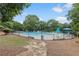 Community pool surrounded by lush greenery and lounge chairs at 1644 Royal Ives Dr, Lawrenceville, GA 30045