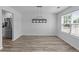 Bright dining room with modern light fixture, wood-look floors, and large window offering ample natural light at 1644 Royal Ives Dr, Lawrenceville, GA 30045