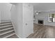 Entryway features stairs leading upstairs and an open living area with a fireplace at 1644 Royal Ives Dr, Lawrenceville, GA 30045