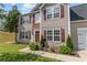 Close-up shot of a charming home with a stone facade, inviting entryway, and well-maintained landscaping at 1644 Royal Ives Dr, Lawrenceville, GA 30045