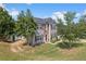 Beautifully landscaped two-story home with stone accents, red shutters, a two-car garage, and a spacious lawn at 1644 Royal Ives Dr, Lawrenceville, GA 30045