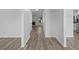 Bright hallway with new wood-look floors leading to a living room featuring a fireplace and backyard views at 1644 Royal Ives Dr, Lawrenceville, GA 30045