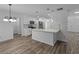 Bright kitchen features white cabinets, stainless steel appliances, and an island with a marble countertop at 1644 Royal Ives Dr, Lawrenceville, GA 30045