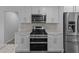 Close up of kitchen features stainless steel appliances and white cabinets at 1644 Royal Ives Dr, Lawrenceville, GA 30045