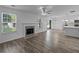 Open-concept living space featuring wood-look floors, fireplace, and a kitchen island perfect for entertaining guests at 1644 Royal Ives Dr, Lawrenceville, GA 30045