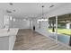 View of the light-filled living room, fireplace, and sliding glass door leading to the backyard patio at 1644 Royal Ives Dr, Lawrenceville, GA 30045