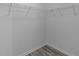 Walk-in closet features custom shelving and modern luxury vinyl plank flooring at 1644 Royal Ives Dr, Lawrenceville, GA 30045