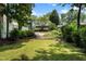Lush backyard with a well-manicured lawn, stone edging and a glimpse of the house at 1772 Ridgewood Ne Dr, Atlanta, GA 30307