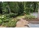 Picturesque backyard featuring brick pathways, lush greenery, and mature trees at 1772 Ridgewood Ne Dr, Atlanta, GA 30307