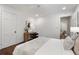 Bright bedroom with a desk, hardwood floors, and white bedding for a cozy restful retreat at 1772 Ridgewood Ne Dr, Atlanta, GA 30307