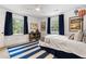 Bright bedroom with two windows, ceiling fan, blue accents, and playful decor at 1772 Ridgewood Ne Dr, Atlanta, GA 30307