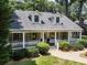 Inviting front porch with white columns on a beautiful home exterior at 1772 Ridgewood Ne Dr, Atlanta, GA 30307