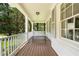 Relaxing covered front porch with swing and view of the wooded front yard at 1772 Ridgewood Ne Dr, Atlanta, GA 30307