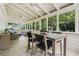 Relaxing screened porch with comfortable seating, a dining table, and views of the green backyard at 1772 Ridgewood Ne Dr, Atlanta, GA 30307