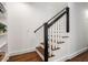 View of a staircase with white risers and black railing leading to the upper level at 1772 Ridgewood Ne Dr, Atlanta, GA 30307