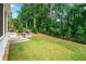 Sprawling backyard with well-manicured lawn, fence, and outdoor kitchen at 310 Braeden Way, Alpharetta, GA 30009