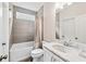 Bathroom featuring a shower-tub combo, a marble countertop and modern fixtures at 310 Braeden Way, Alpharetta, GA 30009