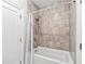 Bathroom with a shower-tub combo, featuring gray tiling, modern fixtures, and a neutral color palette at 310 Braeden Way, Alpharetta, GA 30009