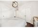 Bedroom with white walls, white bedding, an overhead light fixture and matching wooden furniture at 310 Braeden Way, Alpharetta, GA 30009