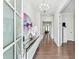 Bright foyer with hardwood floors, modern chandelier, and an open view into the home's living spaces at 310 Braeden Way, Alpharetta, GA 30009