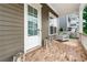 Inviting front porch with brick flooring, white railings, a seating area, and a view of the neighborhood at 310 Braeden Way, Alpharetta, GA 30009