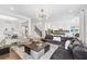 Open-concept living space featuring a spacious seating area, modern decor, and seamless flow to the kitchen at 310 Braeden Way, Alpharetta, GA 30009