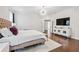 Spacious main bedroom featuring hardwood floors and TV, offering lots of natural light at 310 Braeden Way, Alpharetta, GA 30009