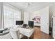 Contemporary office with a large window, modern desk, and double doors leading to the foyer at 310 Braeden Way, Alpharetta, GA 30009