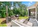 A stunning outdoor kitchen with an outdoor patio and lounge area at 310 Braeden Way, Alpharetta, GA 30009