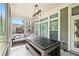 Screened-in patio with furniture and ping pong table, perfect for outdoor entertainment and relaxation at 310 Braeden Way, Alpharetta, GA 30009